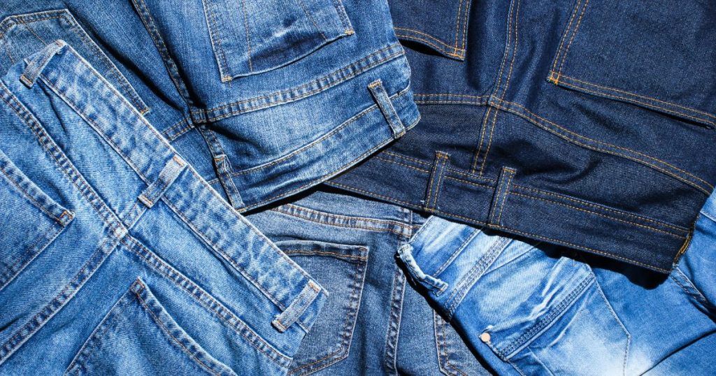 An image showcasing a close-up of a pair of vintage denim jeans, highlighting the unique fade, distressing, and details that make vintage denim so captivating